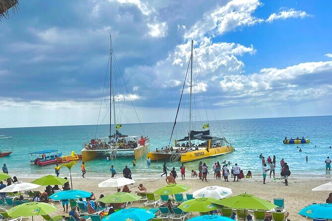 7 Mile Beach Party Catamaran Cruise with Snorkeling & Ricks Cafe - Key Points