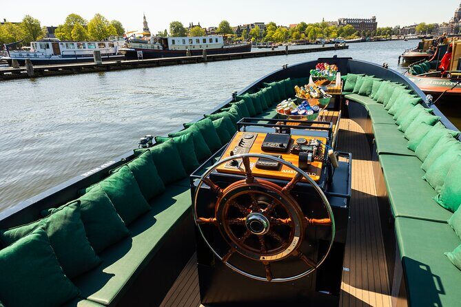 Amsterdam: Guided Open Boat Canal Cruise Including 1 Drink - A detailed look at the tour experience