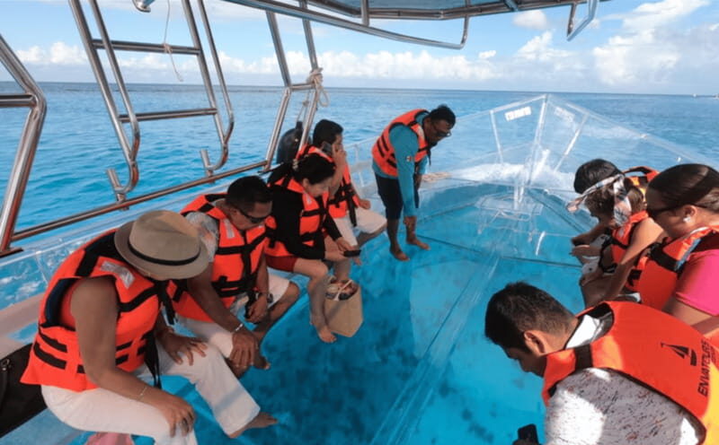 Explore the sea of cozumel in a transprent boat with drinks and snorkel. - FAQ