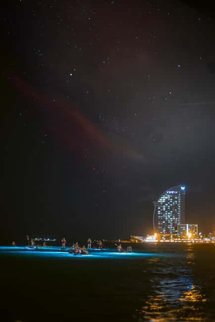 Paddle surf at night with light & drink -photos &videos - Discovering the Magic of Night Paddleboarding in Barcelona