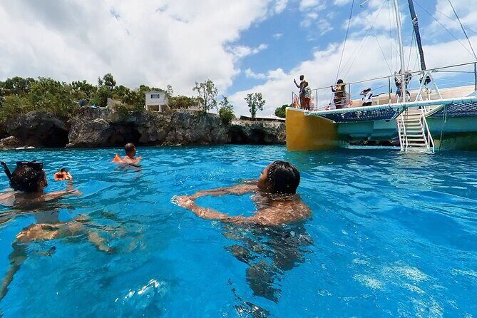 Party Catamaran Sunset Ricks Cafe Negril Open Bar and DJ - A lively Jamaica party cruise combining snorkeling, cliff jumping, and sunset fun